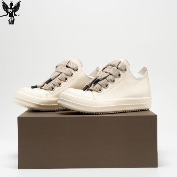 Low-top abrasion-resistant grained calfskin sneakers in off-white.